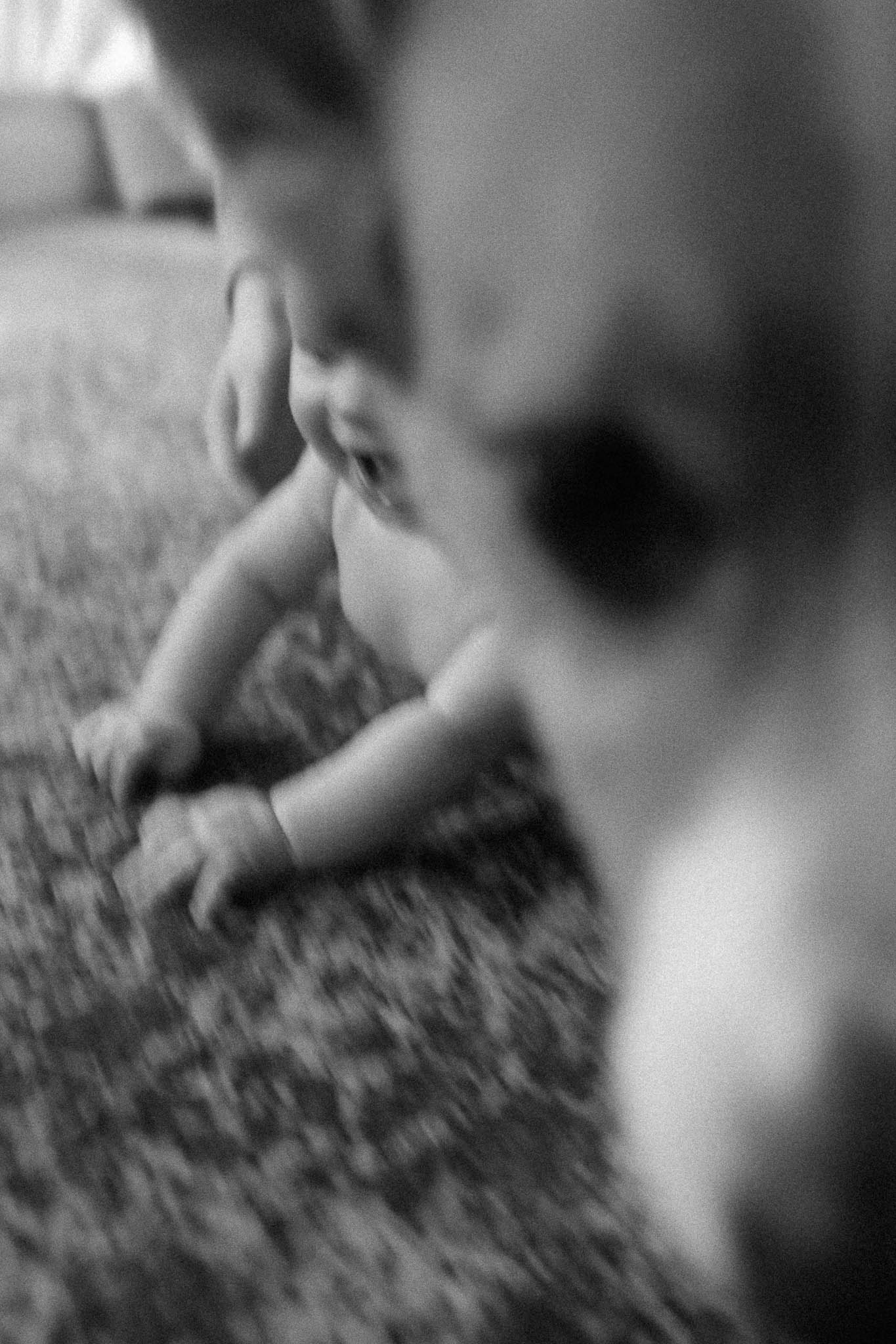 Family cuddling on the couch with their baby during a cozy in-home session in Columbia, MO