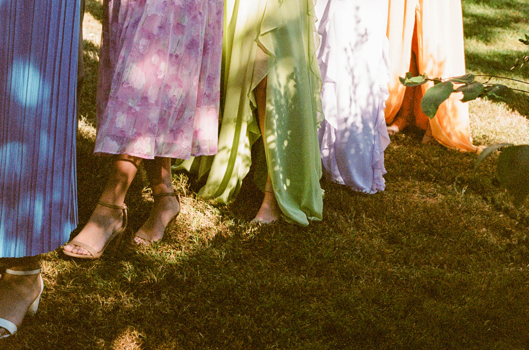 colorful bridesmaids dress standing in grass at historic bell hill in illinois