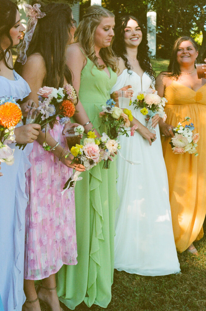  Bride laughing with her friends at the reception, captured in a candid moment, documentary wedding photography showing real connection.