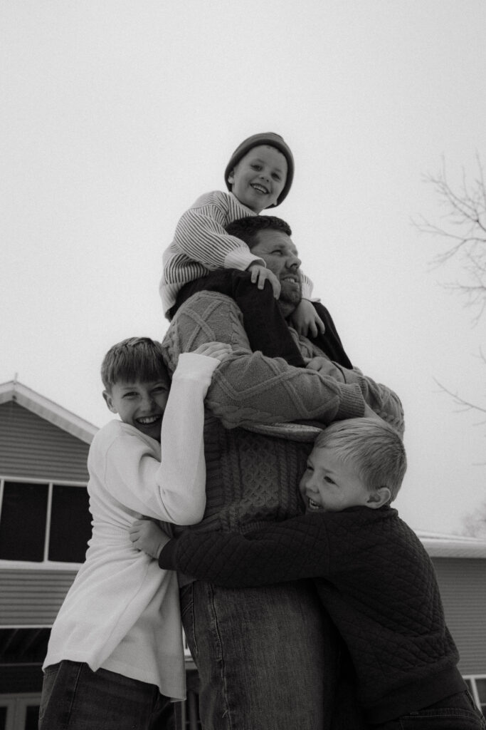 Luxury documentary family photography in Columbia MO capturing parents laughing with their kids at home