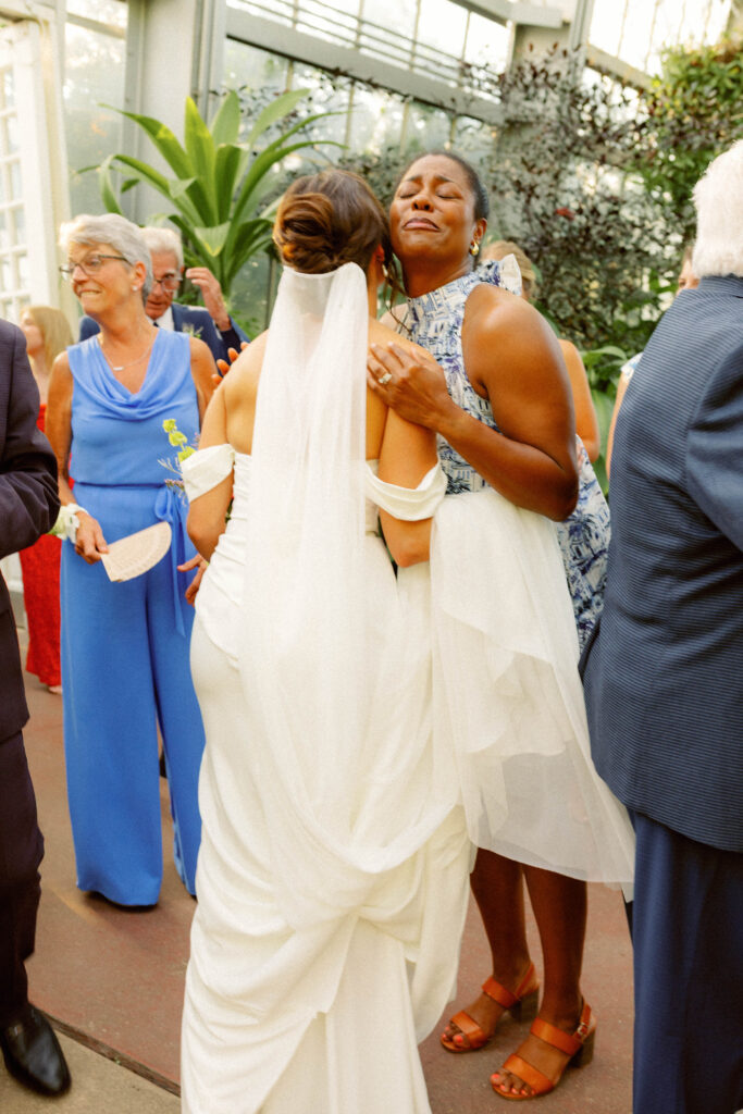 guest hugs bride after loose-editorial wedding ceremony