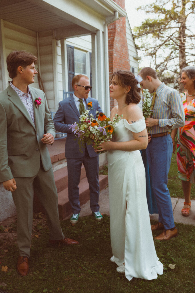 wedding party waiting for ceremony to begin during backyard wedding