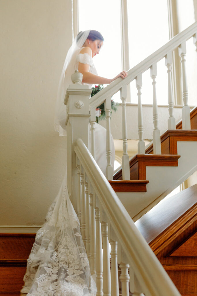 Bride walking upstairs in historic home
Elegant backyard wedding in Missouri — bride walking upstairs in historic home, presence-driven and artfully captured by Emily Ambie.
