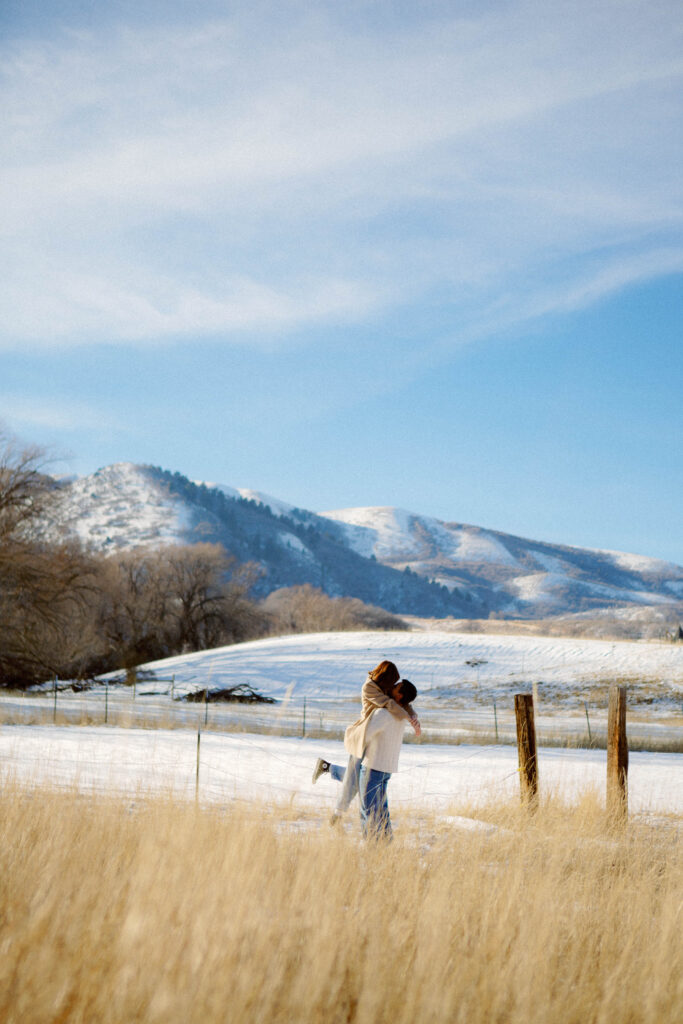 Cozy editorial engagement photography in Utah with snowy cabin surroundings