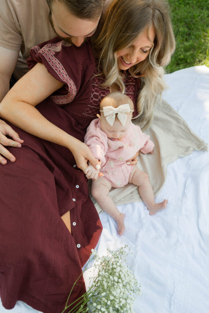 Family photo session near MKT Trail Columbia Missouri in open field with natural light