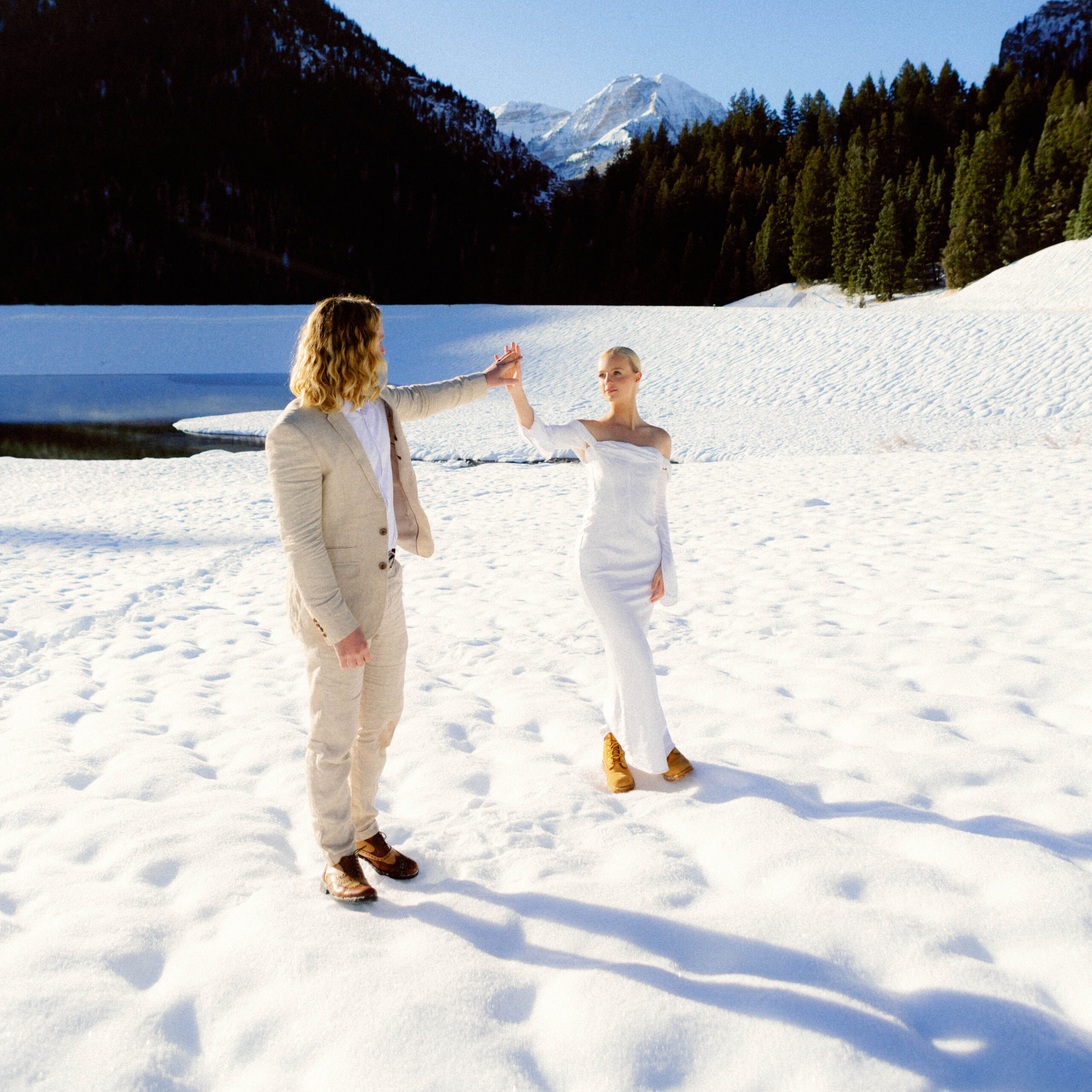 bride and groom touch hands in an artful, editorial moment during elopement in Utah