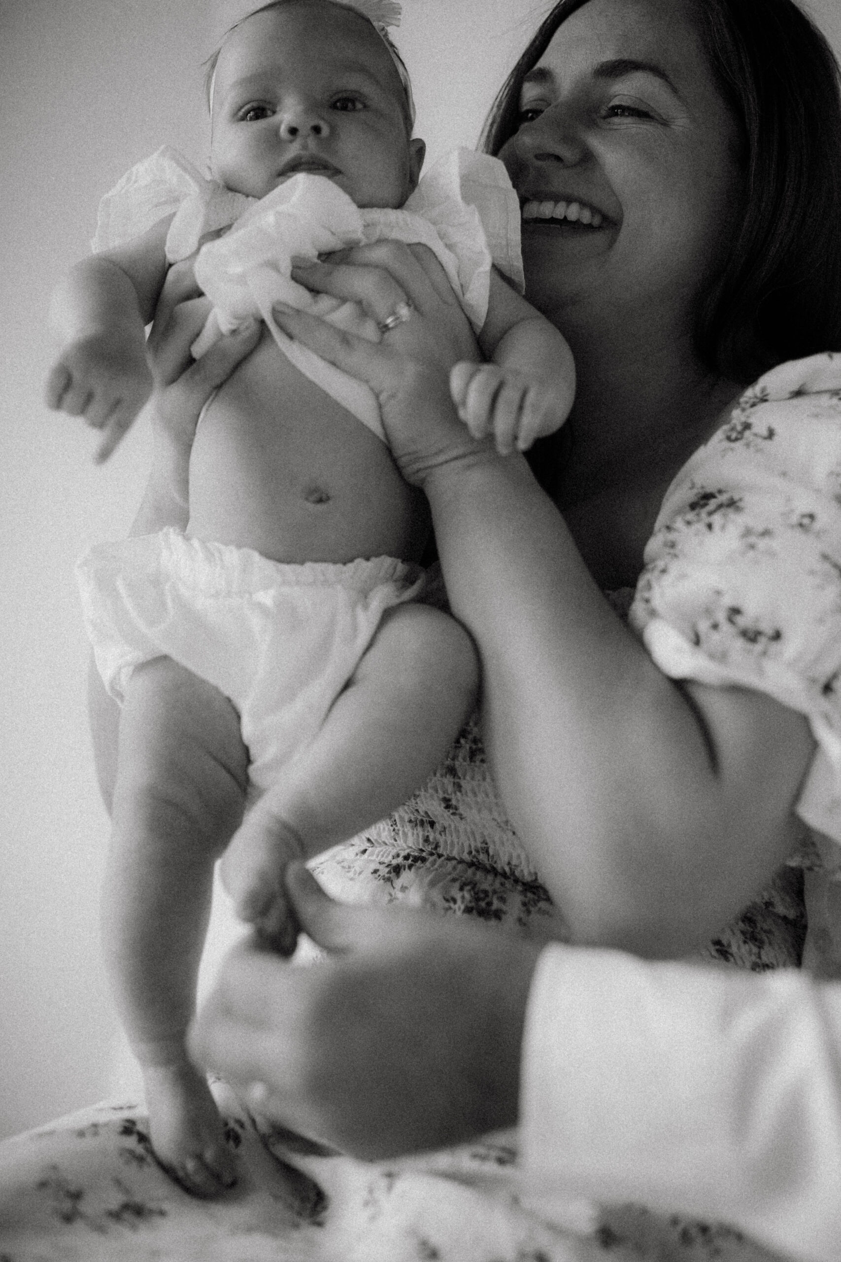 mom holds 3 month daughter during newborn studio session in kansas city