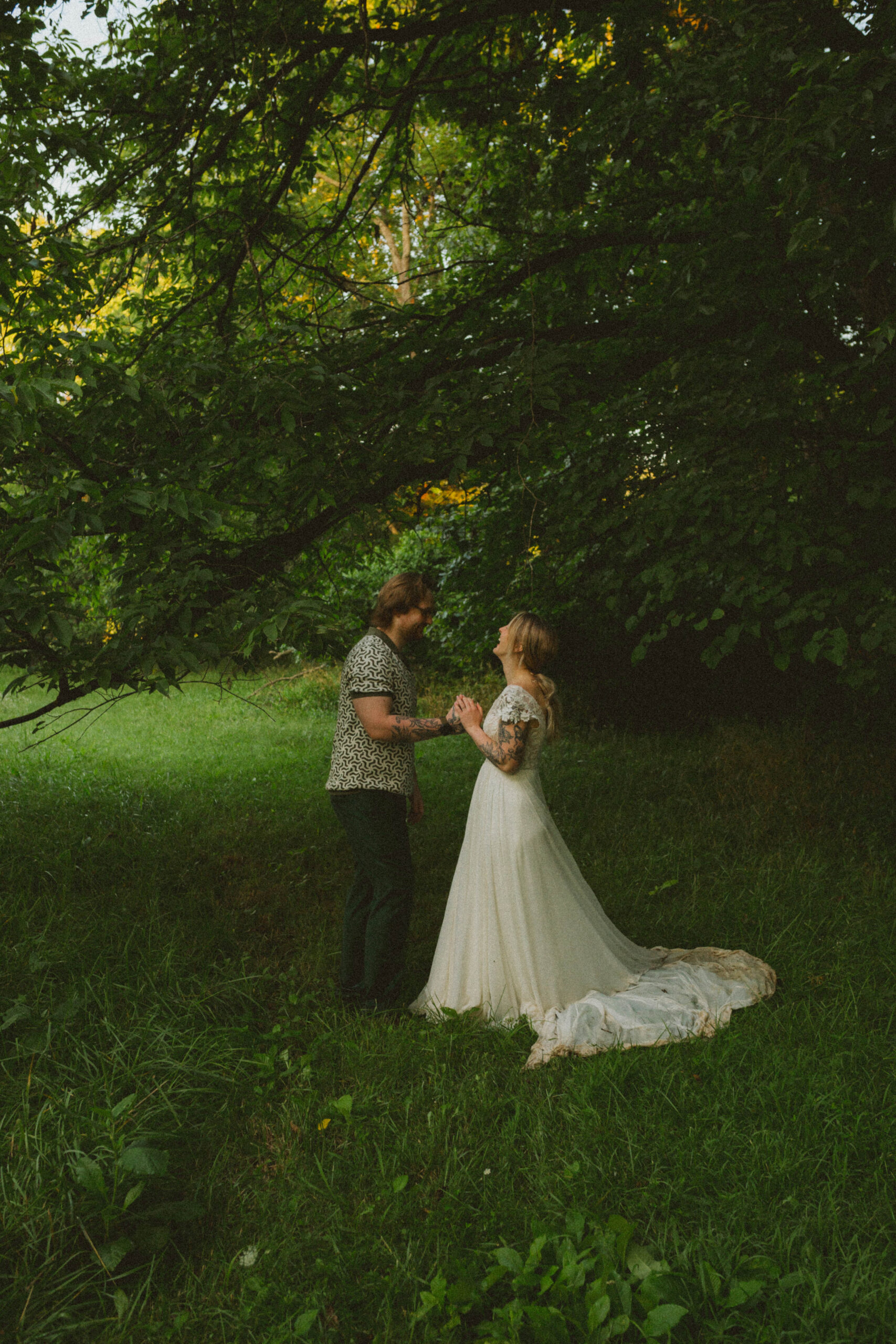 bride and groom hold hands while saying vows during columbia missouri elopement